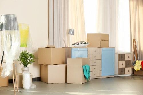 Removal team pricing a move from a Putney flat with boxes and furniture