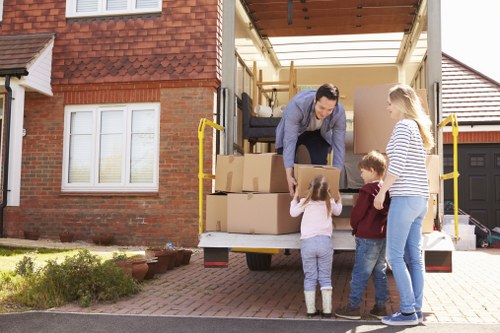 Removal team loading household items into a moving van