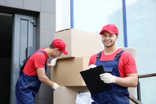 Removal team preparing belongings with safety equipment during a move in Putney