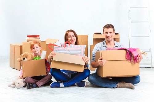Professional removal team handling boxes during a Putney home move