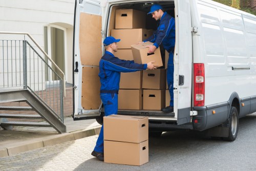 Removal team preparing safely for a move with equipment and protective handling