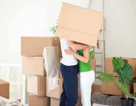 Professional movers carrying boxes during a Putney apartment relocation