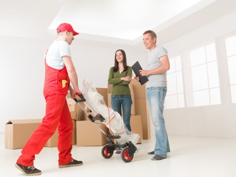 Professional movers handling boxes during a Putney house relocation