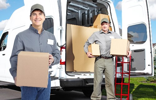 Workers using correct lifting techniques during a removal job